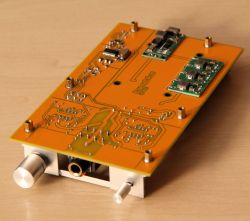 Printed circuit board of a headphone amplifier with electronic components.