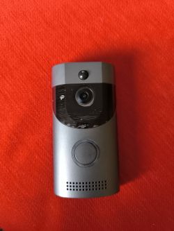 Video Doorbell with Camera on Red Background Video doorbell on a red background