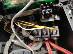 Interior of a coffee machine showing electronics and wiring.