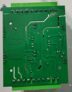 Green printed circuit board underside with visible traces and solder points