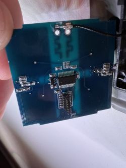 The image shows a section of a printed circuit board with electronic components and soldered connectors.