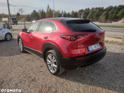 Red Mazda CX-30 parked in a parking lot.