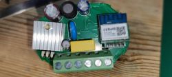 Close-up view of an electronic module with various components, including capacitors and a WB2S module.