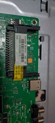 Close-up of a TV motherboard with labels and ports.