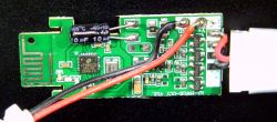 PCB with electronic components, a capacitor, and wires.