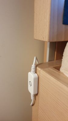 Touch LED switch mounted on a bed frame