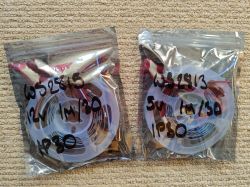 Two LED strips in ziplock bags labeled with marker, lying on beige carpet.