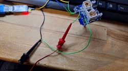 Connection wires attached to an electronic board on a desk.