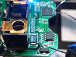 Close-up of a printed circuit board of a smart device with visible electronic components and wires.