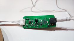 BK7231N Board with Connected Power Supply Printed circuit board with electronics and attached white connector.