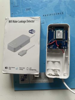 WiFi Water Leakage Detector - Internal View WiFi water leakage detector with open casing and packaging.