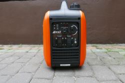 Portable AIVOLT Generator on Cobblestones Portable AIVOLT generator in an orange casing on a cobblestone surface.