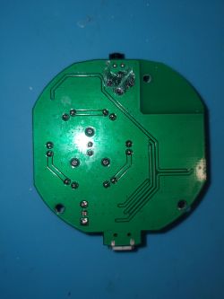 Bottom view of a PCB with visible traces.