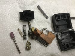 Disassembled Switch of Celma PRCb Drill Disassembled drill parts on a paper towel.