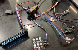 Electronic set on a table with wires, display, and remote control.