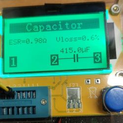 Capacitor tester display showing ESR and Vloss values.