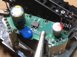 Close-up of a PCB inside a USB socket module with capacitors, SMD parts, and solder joints