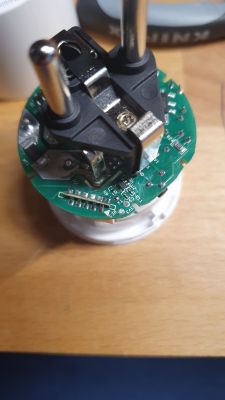 Top view of an open electrical plug with visible electronic components.
