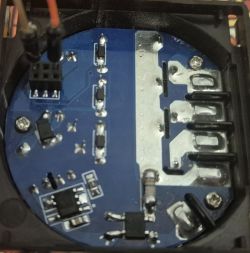 Close-up of a printed circuit board marked TW2-0003A with visible electronic components and connected wires.