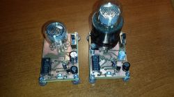 Nixie Tube Testers on Wooden Surface Two Nixie tube testers on a wooden surface, with different bases for the tubes.