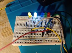 Five LEDs on a breadboard with multicolored lighting
