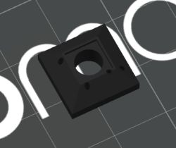 Black plastic part with central hole and four smaller holes around it