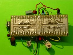 Prototype Electronic Circuit on a Prototype Board Prototype electronic circuit with an unetched board on a green background