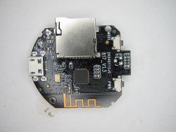 Round PCB with microSD and micro USB ports A round printed circuit board with a micro USB port, a microSD card slot, and electronic components.