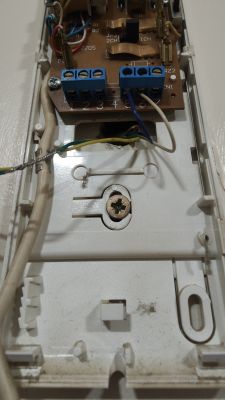 Interior of a technical casing with visible terminals and wires.