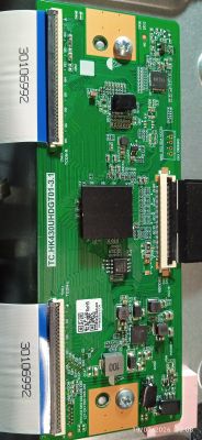 Close-up of a green PCB with ICs, two ribbon cables on the left, and a connector on the right