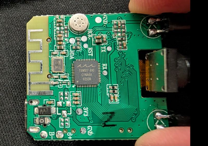 Close-up of a PCB with microphone, Wi-Fi antenna, and TXW817-810 chip