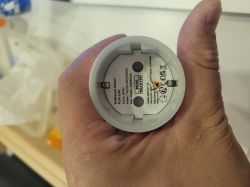 Bottom of a round BURG-WÄCHTER device held in a hand, with label and CE/UKCA marks.
