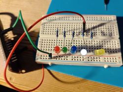 Close-up of a breadboard with connected LEDs and resistors.