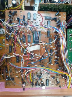 Wnętrze urządzenia TEAC z dużą płytką PCB, wieloma przewodami i układami scalonymi DIP.