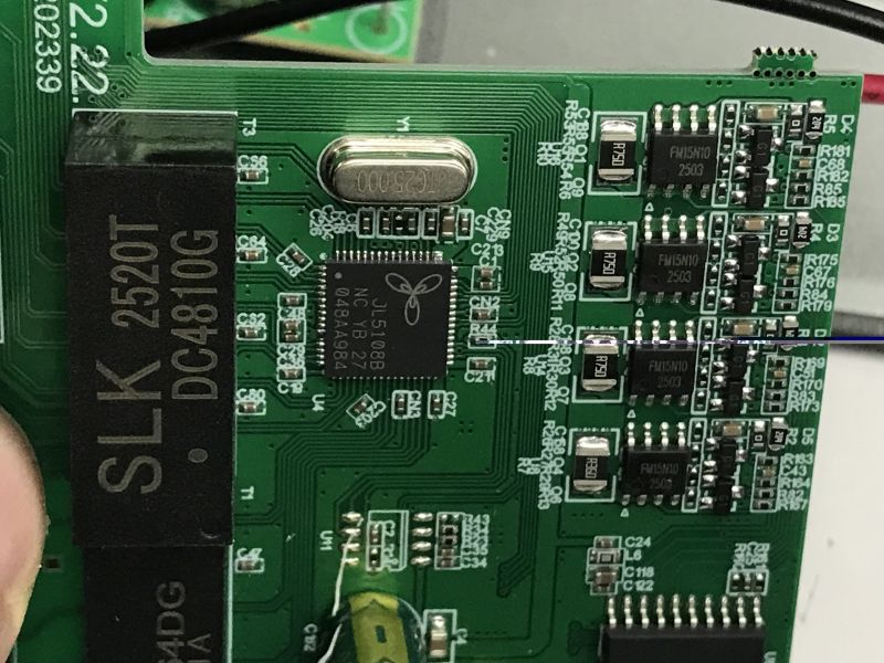 Close-up of a PoE switch PCB showing JL5108B IC, SLK transformer, and SMD component sections
