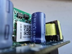 Close-up of a circuit board with an unsoldered capacitor.
