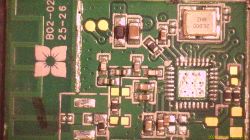 Close-up of a PCB with a QFN IC, 26.000 MHz crystal can, and surrounding SMD components
