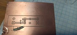 Close-up of two PCB boards with etched tracks on a workshop table.