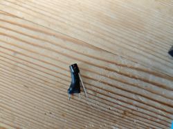 DS18B20 Temperature Sensor DS18B20 temperature sensor with heat shrink tubing on a wooden background.