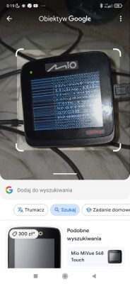 Kamera Mio MiVue 568 z ekranem wyświetlającym zakłócenia.