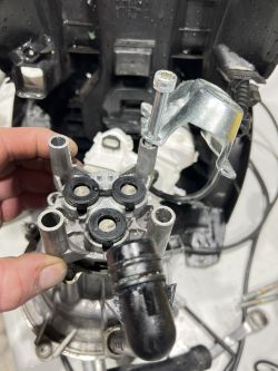 Close-up of a damaged K5 head with visible pipes and a clamp.