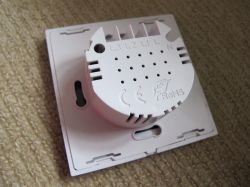 Back of a white Axus three-touch light switch with markings L1, L2, L3, and N.