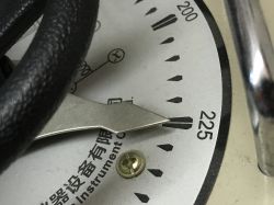 The needle on an autotransformer gauge showing a voltage reading around 225V.