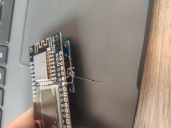 ESP8266 module connected to an OLED display with visible hand-soldered wires.