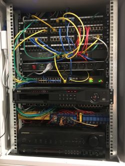 Server rack with cabling and networking devices.