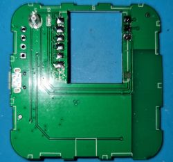 Circuit Board with Removed Integrated Circuit The image shows a circuit board of a device with an integrated circuit visible in the upper left corner and an empty space where a central chip was removed.
