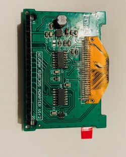 Green printed circuit board with visible electronic components and an edge connector.