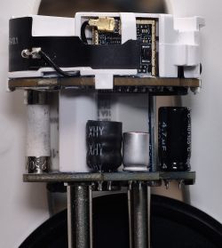 Interior of a smart plug with visible electronic components and a communication board.