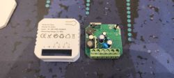 Two electronic parts: a white labeled module and a green PCB with a screw terminal block