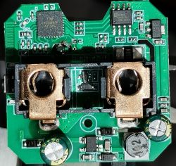 Close-up of a green printed circuit board with integrated circuits and electronic components.